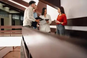 LaCava Law Firm attorneys discussing legal documents with clients in a modern office setting, providing
